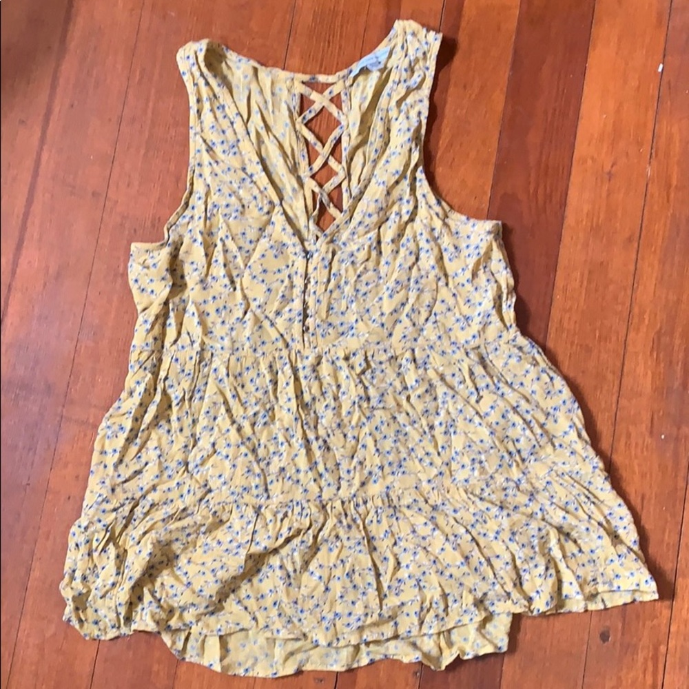 Yellow tank top with blue flowers on it